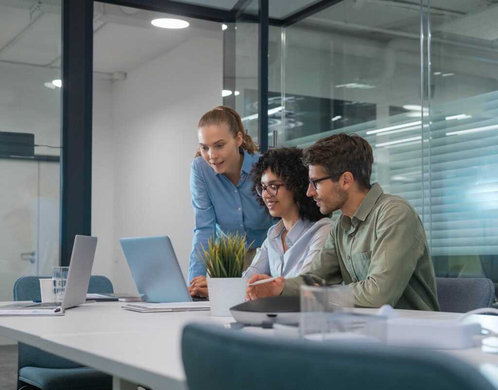 Team working on computer in office.
