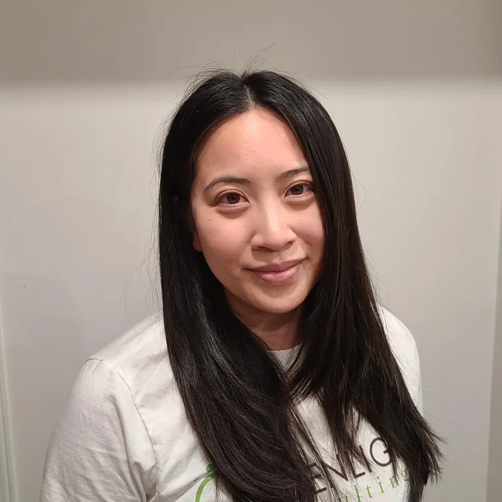 A headshot of a woman with a Greenlight Consulting t-shirt